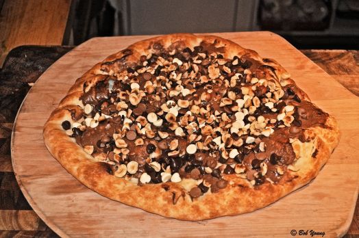 Chocolate Pizza with hazelnut spread, semisweet5 chocolate chips, milk chocolate chips, white chocolate chips and toasted hazlenuts