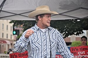 Chance Requa owner of Requa Farms in Twin Falls, Idaho, speakers to the crowd.  He emphasized the fact that he produces a product, we buy the product and he must then produce more product. It's an endless cycle.