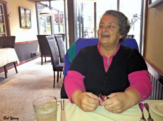 Robin is enjoying the ambiance and talking wine to the distributor and our Server, Chris.