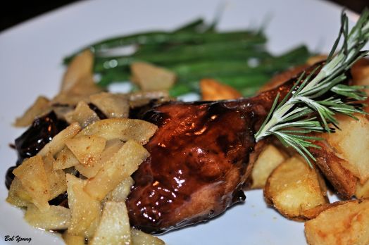 Confit de Canard Duck confit served with roasted potatoes and Calvacios flambe apples