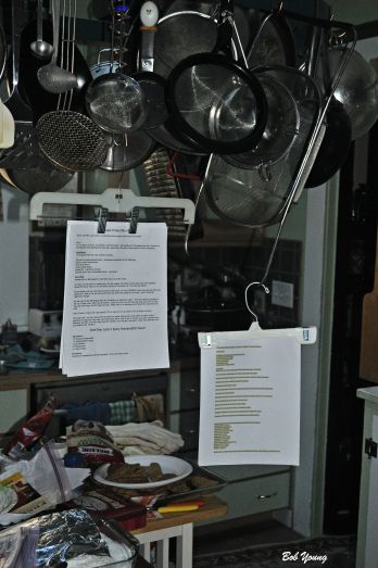 Recipe holder made from "skirt" hangers. Hang them where you are working and they are out of the way. 