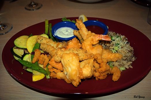 Captain Alex’s Seafood Platter A medley of cod, salmon, halibut, mahi mahi, Jumbo shrimp, calamari and clams battered and deep fried to perfection. Served with chef’s choice sautéed vegetables and wild rice 18.99