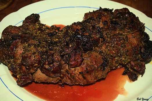 The cooked lamb is resting to redistribute the juices.