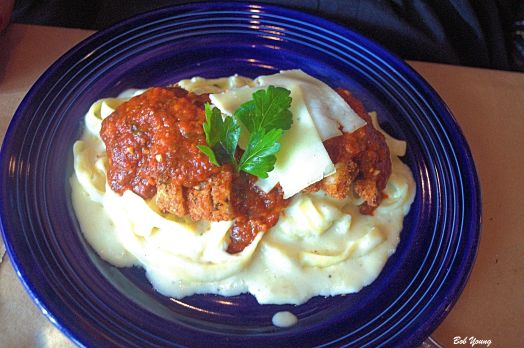 CHICKEN ASIAGO  gremolata chicken breast over fresh fettuccine in Asiago-garlic cream, finished with tomato-pesto  sauce. served with the house or Caesar salad 
