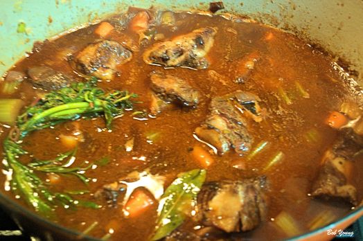 Beef short ribs added to the pot along with the herb bundle.