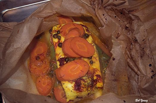 Opening the parchment. Be careful. There is steam in the packet.