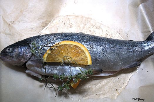 Stuff the trout with 5 sprigs of Lemon Thyme and 2 sprigs of French Thyme.  Add 1 slice of orange. For generating the steam, we used a\ 2011 Dusted Valley Vineyards Pinot Gris. About 2 Tablespoons.