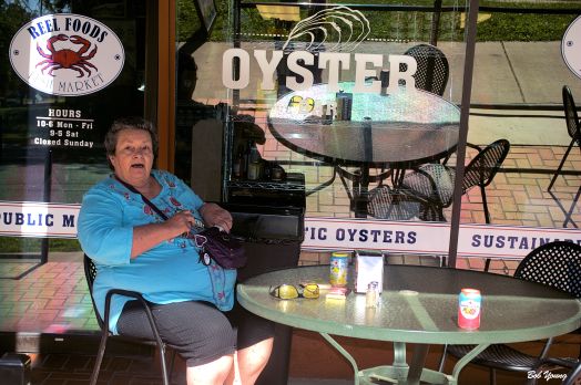 Robin sitting on the patio at Reel Foods Oyster Bar waiting for our Lobster Rolls..
