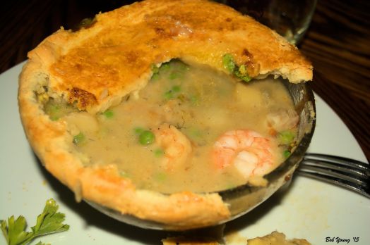 Break open that luscious crust and one exposes peas, pearl onions, shrimp, scallops and lobster.