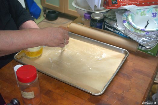 Brush unsalted butter on the parchment paper.