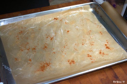 Dust the buttered parchment paper with sea salt. fresh ground black pepper and cayenne pepper.