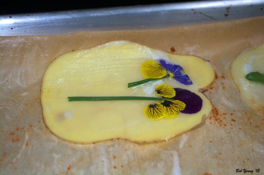 Herbs and flowers placed to "paint" a picture.