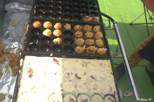 The dumplings being made. The octopus ones seem to be the standard for this food cart. Other types are also available. They usually have two different types being prepared.