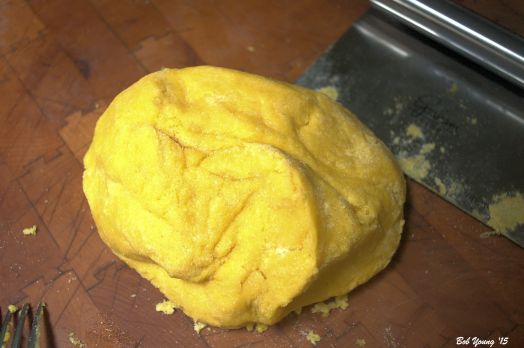 The pasta dough is ready to knead. Notice the pastry knife used to help in the kneading process.
