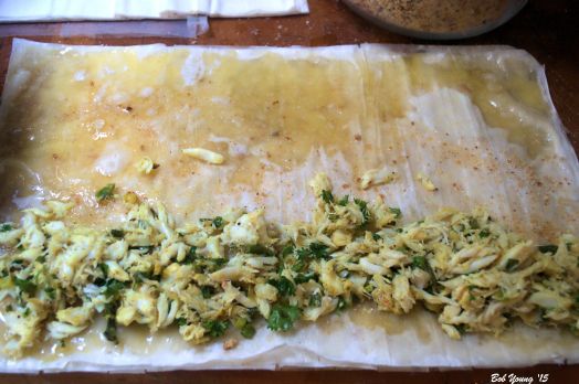 1" wide row of the crab mixture is placed on the phyllo dough. Roll into a "tube" carefully.