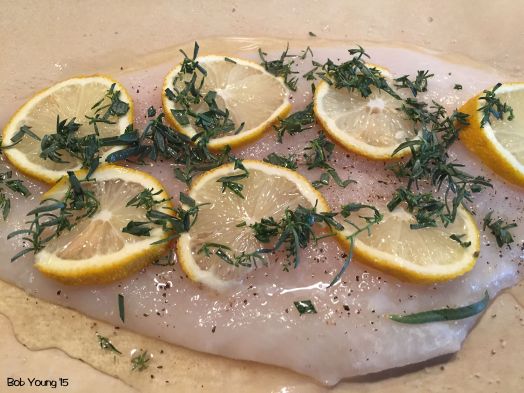 The flounder is set in the parchment with lemonn slices, limoncello, Texas tarragon (which has a slight bite to it compared to the French tarragon) and salt and pepper.