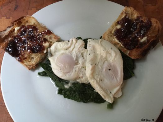 Fresh Spinach Steamed in Water and Tarragon Vinegar and then topped with Two Soft Poached Eggs. Toasted Sourdough with Raspberry Jam.