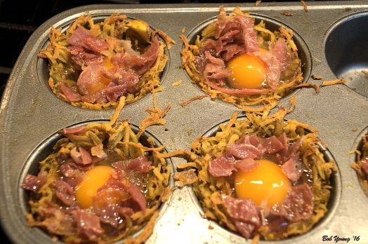 Eggs are placed in the cups and baked for about 20 minutes until the whites are set.