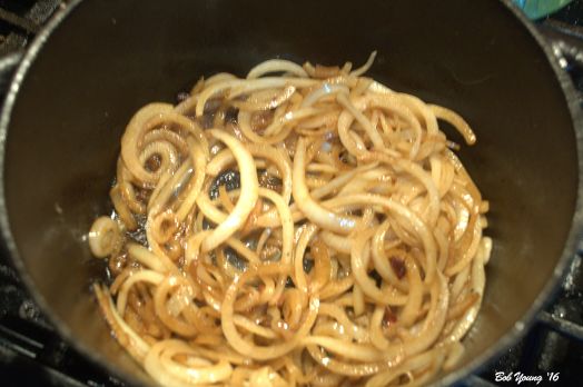 Onions are caramelizing in the beef fat.