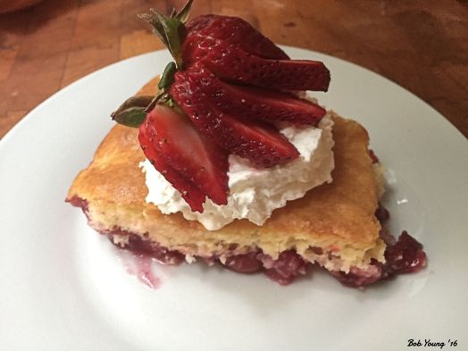 Dump Cake with trawberry fan on whipped cream