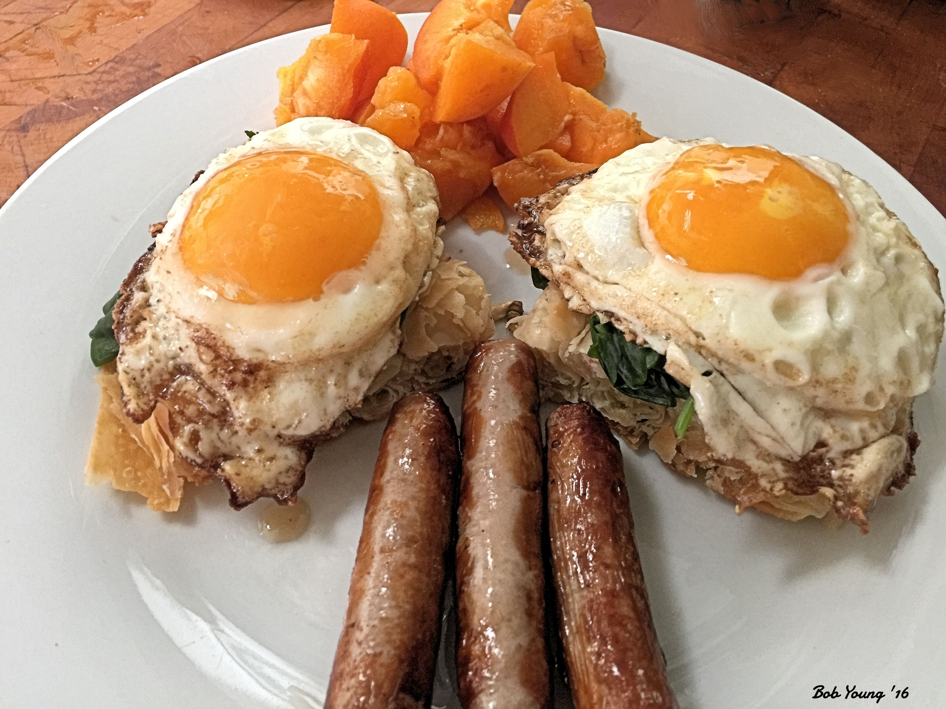 Sunnyside Up Eggs  on Spinach and 5 Greek  Cheese Filo Sausage Links Apricot Chunks