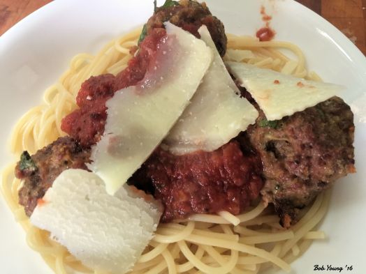 The plated dinner of Spaghetti, Meatballs and Marinara with Shaved Pecorino