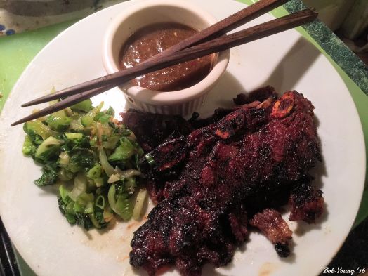 Plated with a dipping sauce and sautéed Bok choy. 