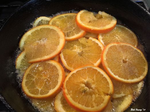 Caramelizing the orange slices. I use a mandolin to get the thin slices.